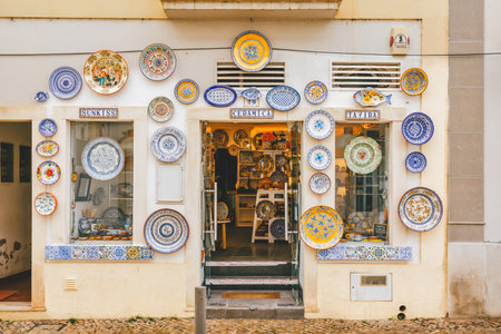 Tavira, Portugal, January 8, 2024. Colorful ceramic plates adorn the front of a ceramic shop in Tavira, Portugal, inviting customers inside.のeditorial素材