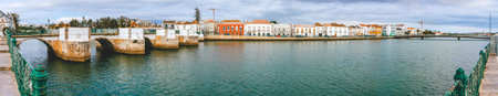 Two bridges and river waterfront in Tavira, Portugal, panoramic view.
