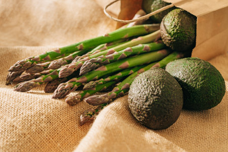 Green asparagus, and fresh avocados close-up on rustic backgroundの写真素材