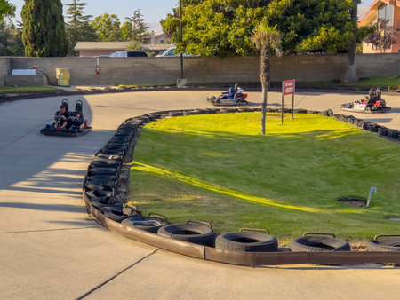Santa Maria, California, USA - July 20, 2024. People enjoying a go-kart ride on a sunny day at a track.のeditorial素材