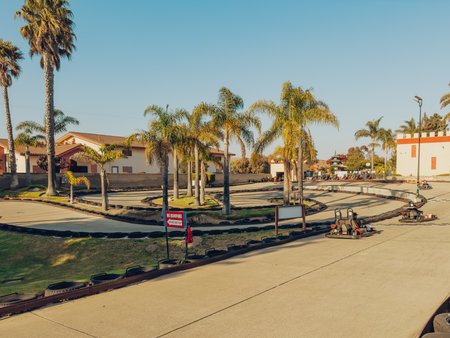 Santa Maria, California, USA - July 20, 2024. People enjoying a go-kart ride on a sunny day at a track.のeditorial素材