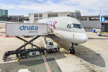 San Francisco, California, USA - August 2, 2024. Airplane being catered at the gate by a service truck preparing for an upcoming flight.のeditorial素材