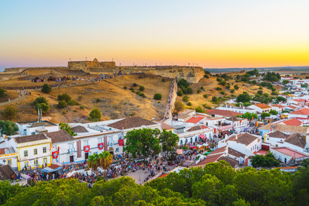 Celebration of medieval heritage with lively crowds and festive decorations in Castro Marim.の写真素材