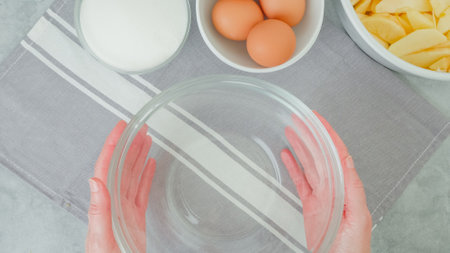 Apple cake recipe. Ingredients for baking needs close-up on a kitchen table, woman hands, flat lay