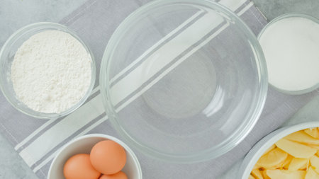 Apple cake recipe. Ingredients for baking needs close-up on a kitchen table, flat layの写真素材