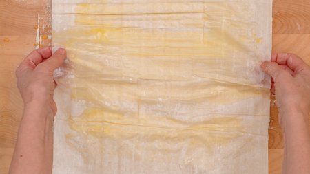 Brush each layer of phyllo dough with melted butter, step by step baking process, recipe