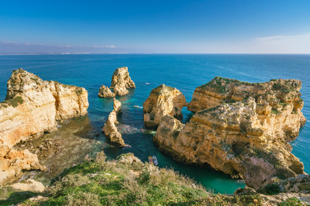 Rock formations that are scattered all over the shore around Lagos, Algarve, Portugalの写真素材