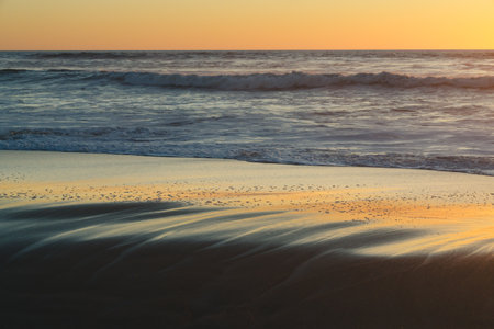 Sand beach at sunset, tranquil scene, copy space for the textの写真素材