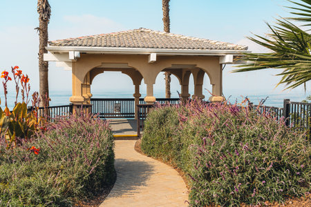 A charming gazebo adorned with vibrant flowers nestled atop a seaside cliff, offering breathtaking ocean views, California Central coastの写真素材