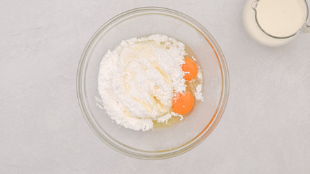 Cream cheese and powered sugar in a glass bowl, flat lay with a copy spaceの写真素材