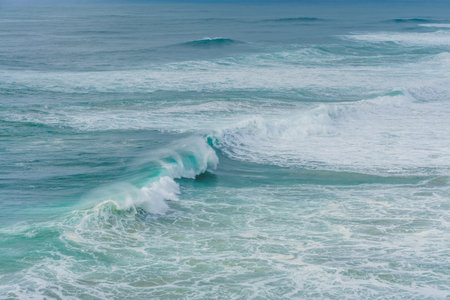 The dance of Nazares waves captured in a moment of oceanic power and grace.の写真素材