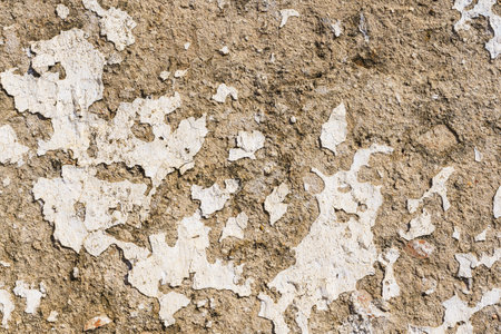 textured background of an old wall with cracked and peeling paint.の写真素材