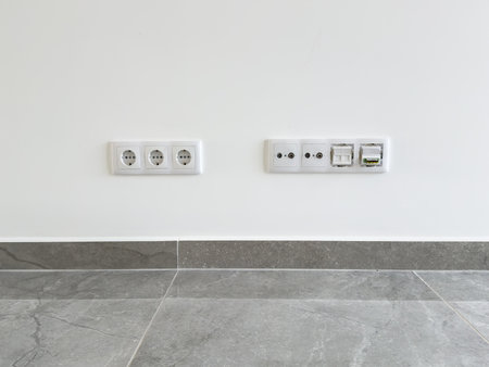 Set of power sockets and communication ports installed in a clean, minimalist interior.の写真素材