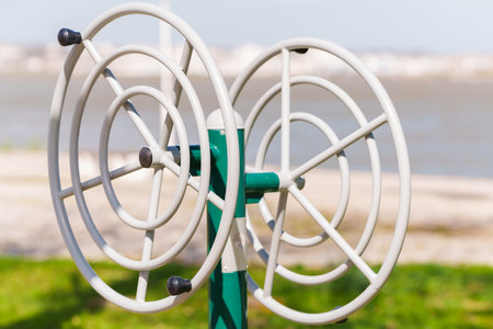 Public exercise machine with rotating wheels designed for upper body workoutsの写真素材