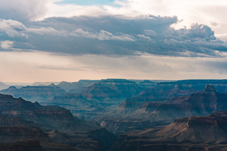Thick clouds stretch across the sky above the dramatic depths of the Grand Canyon.の写真素材