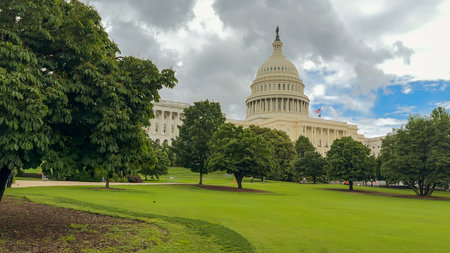 Washington D.C, USA, May 22, 2025. The U.S. Capitol stands in the distance behind a lush green lawn...