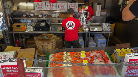 Washington D.C., USA, May 25, 2025. Crabs are sorted in open trays alongside boxes and wooden baskets at the Jessie Taylor Seafood market.のeditorial素材