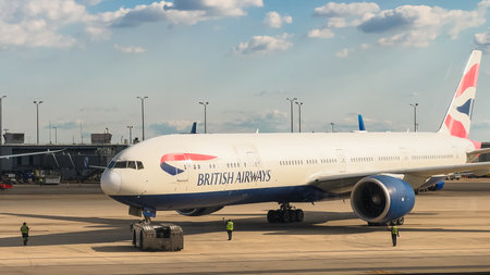 Washington D.C., USA, May 26, 2025. Ground crew assist a British Airways airplane as it prepares to taxi from the terminal at an international airport.のeditorial素材