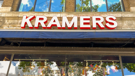 Washington D.C. USA - May 24, 2025. The bold red and white sign of Kramers stands above the glass storefront decorated with pride flags.のeditorial素材