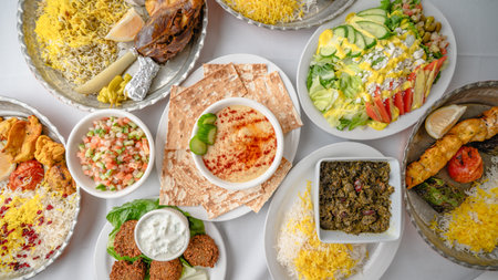 A vibrant assortment of Persian dishes including grilled meats, vegetables, stews, salads, hummus,...
