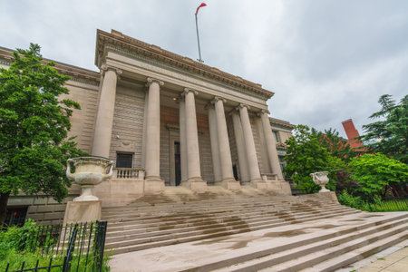 Washington D.C., USA - May 21, 2025. Grand neoclassical building with tall columns and wide stairs under a cloudy sky.のeditorial素材