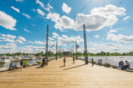 Washington D.C., USA - May 24, 2025. People relax, socialize, and enjoy the sunny riverside...
