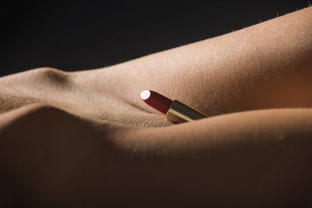 Intimate cosmetics. Red lipstick. Female body.