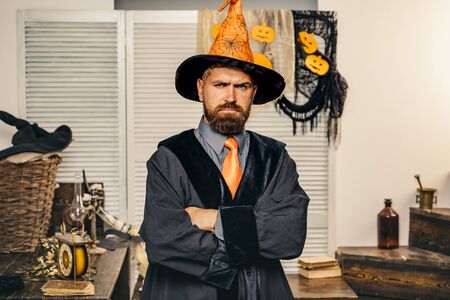 A man in a suit with pumpkin and smile with bow tie. Colorful pop art background. Halloween party invitation. Halloween hipster pumpkin. Magic hat. Man with pumpkins and treat.の写真素材