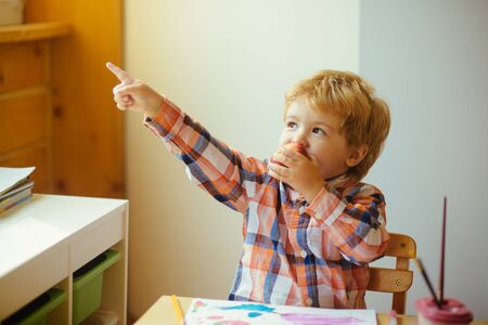 The child eats an apple and plays. Healthy snack. Beautiful boy. Lunch at home.