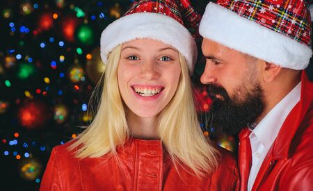 Happy Santa couple. Christmas background. Happy New Year. Cute happy couple celebrating New Year...