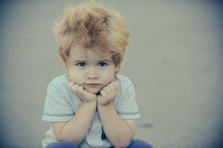Sad boy. Beautiful child. Frustration and melancholy. Childrens emotions.の写真素材