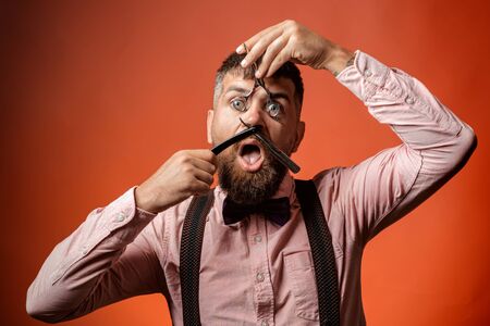 Barber portrait. Man with barbershop equipment. Attractive guy. Funny photo.