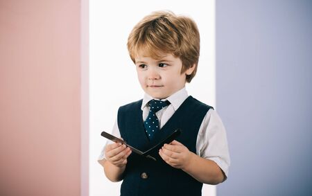 Little barber. The boy holds a shaving blade. Barbershop assistant. Future Muschin. Baby with a razor. How to teach a boy to shave.の写真素材