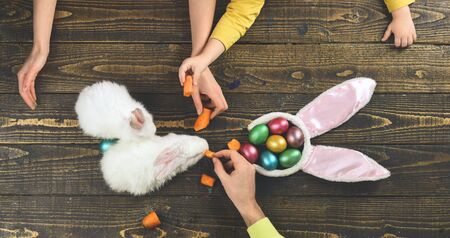 Mother, father and kid painting Easter eggs. Bunny ears, easter egg, easter rabbit - easter day...
