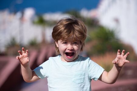 Happy boy screaming into camera. Lots of emotions, emotional intelligence. The child plays a...