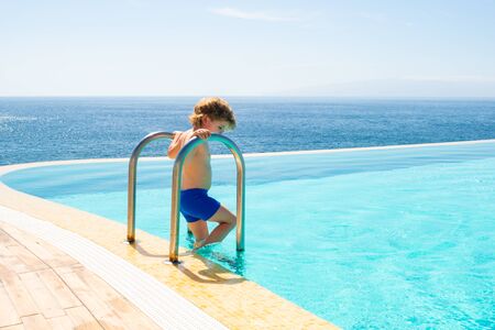 Water mood. Summer vacation. Best pool close to the sea. Boy and pool