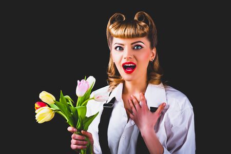 Spring present. Flower for loved one. Woman with tulips. Beautiful young girl.の写真素材