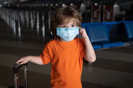 Little American child wearing mask for protect against virus. Stay at home. Social distancing crisis.の写真素材