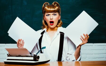 Bureaucracy. Work with papers. Beautiful woman holding a white paper.の写真素材