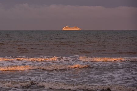 Golden waves on the Atlantic ocean. Beautiful sunset on the oceanの写真素材