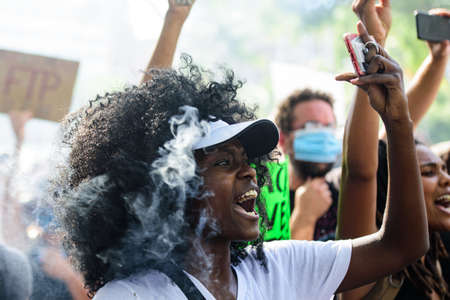 Miami Downtown, FL, USA - MAY 31, 2020: Beautiful black woman in protest. Black Lives Matter. Many american people went to peaceful protests in the US against the George Floyd death.のeditorial素材