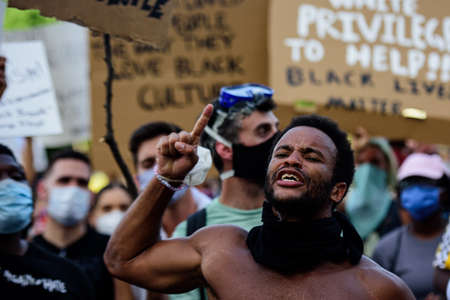 Miami Downtown, FL, USA - MAY 31, 2020: African American Protester during a demonstration in Miami.のeditorial素材
