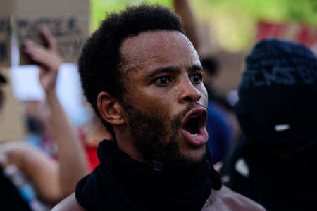 Miami Downtown, FL, USA - MAY 31, 2020: Peaceful marches, clashes with police in Miami. Peaceful marches in Downtown Miami. Black man.のeditorial素材
