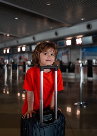 Happy travel. Child with a suitcase at the airport.の写真素材