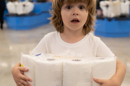 Shortage of toilet paper. Child and toilet paper block.の写真素材