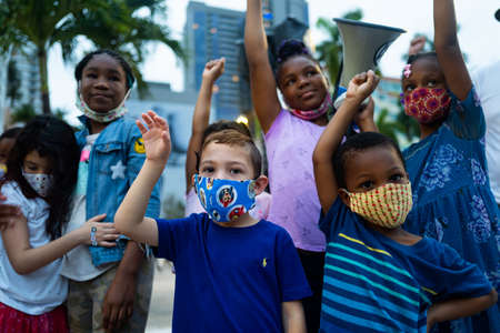 Miami, FL, USA - JUNE 7, 2020: White and black kids friend together. Anti racism demonstration. Children of different races togetherのeditorial素材