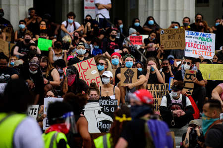 Miami Downtown, FL, USA - JUNE 12, 2020: Black Lives Matter. Skin color is not a weapon poster. Mass protests in the USA. White and black people against racism and crueltyのeditorial素材
