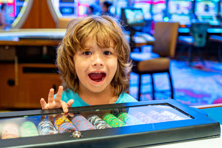 Happy boy in the casino. Gambling. Entertainment and leisure. Casino chips. Child.の写真素材