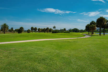 Walking path through golf courses. A park. Golf club in the USA. Green lawn for golf.の写真素材