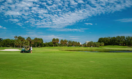 Golf club in the USA. Nature and sport. Panorama View of Golf Course with putting green. Golf course with a rich green turf beautiful scenery.の写真素材